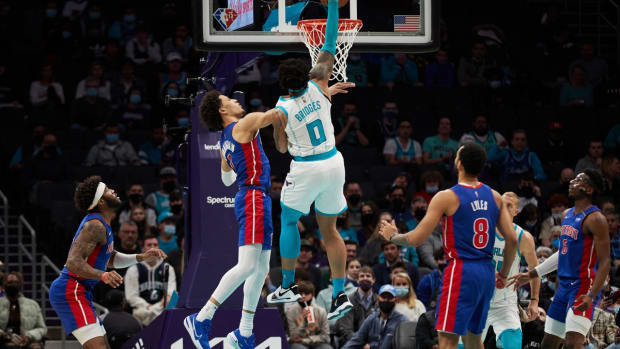 Jan 5, 2022; Charlotte, North Carolina, USA; Charlotte Hornets forward Miles Bridges (0) dunks over Detroit Pistons guard Cade Cunningham (2) during first quarter action at Spectrum Center. Mandatory Credit: Brian Westerholt-USA TODAY Sports
